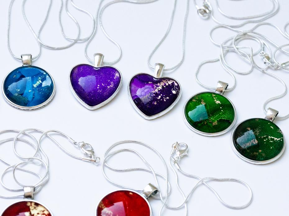 Heart shaped & round pendant necklaces containing unique alcohol ink art sealed with glass cabochons